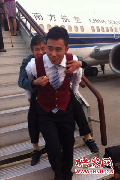 南航帥小伙兒背古稀老人下飛機 南航帥小伙兒背古稀老人下飛機