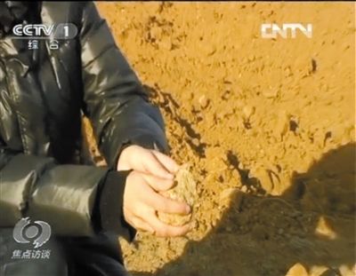 麻剛沙系麻剛石粉碎而成。記者找到一塊麻剛石,一捏就碎成粉末,硬度非常差。央視截圖 麻剛沙系麻剛石粉碎而成。記者找到一塊麻剛石,一捏就碎成粉末,硬度非常差。央視截圖