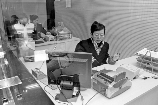 2月16日,鄭州市自來水總公司鄭東新區一營業廳,柜臺內工作人員正在為市民辦理業務 2月16日,鄭州市自來水總公司鄭東新區一營業廳,柜臺內工作人員正在為市民辦理業務