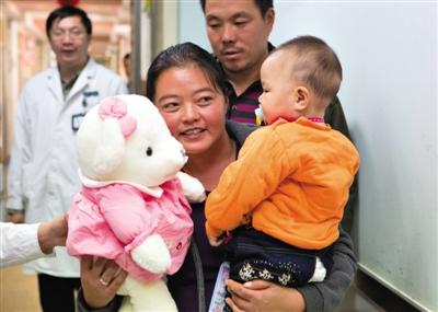 昨日上午,被扎針女嬰的母親抱著孩子和醫護人員送的玩偶準備出院,院方稱孩子術后恢復良好。記者 高瑋 攝 昨日上午,被扎針女嬰的母親抱著孩子和醫護人員送的玩偶準備出院,院方稱孩子術后恢復良好。記者 高瑋 攝